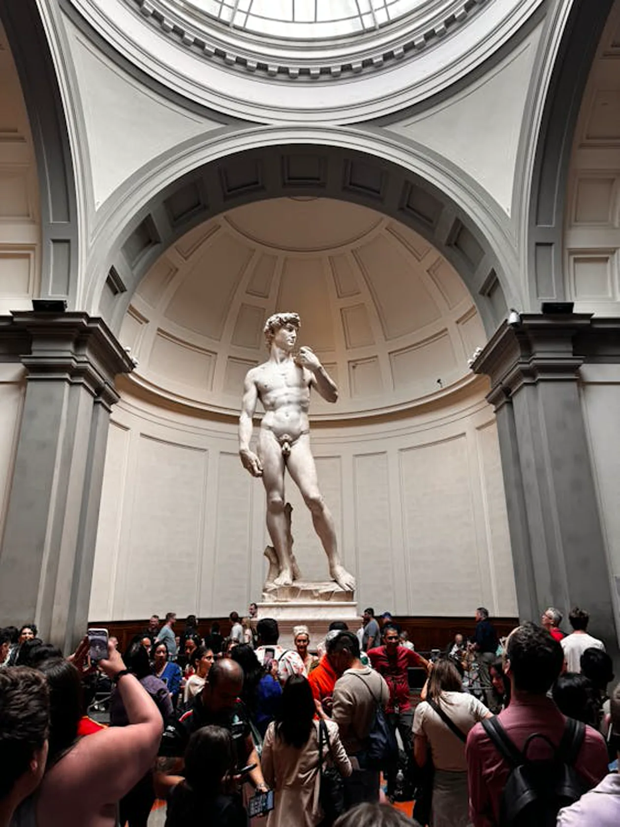 The Tribune room of the Accademia Gallery with David under the dome and visitors below