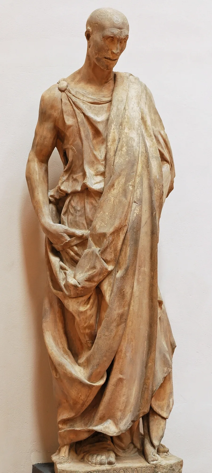 Donatello's Habakkuk, the 'Zuccone': a bald, gaunt prophet wrapped in a heavy cloak, with Donatello's signature on the base, in the Opera del Duomo Museum