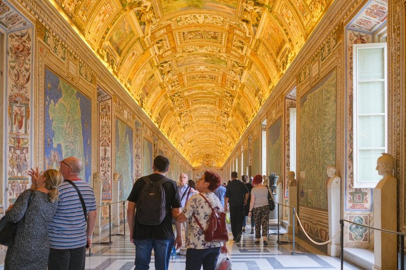 Vatican Museums — Gallery of Maps corridor with painted ceiling and visitors