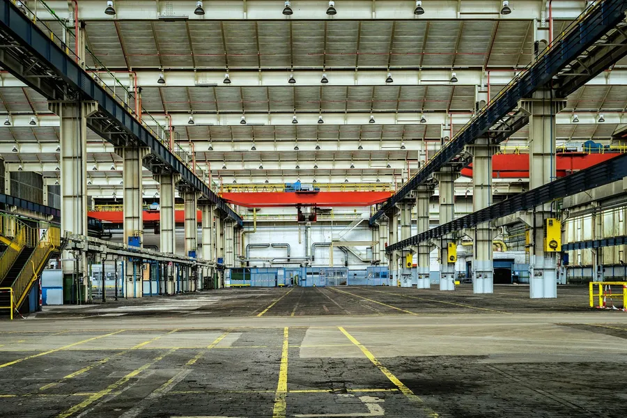 Vast interior of a former industrial power station, now an art gallery space with high ceilings