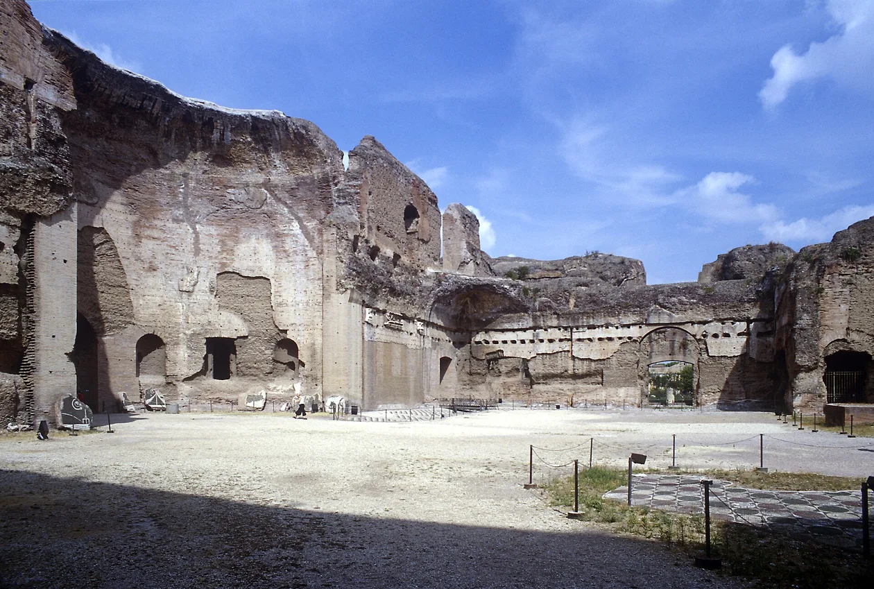 Brick walls of the Baths of Caracalla rising several storeys above the palaestra
