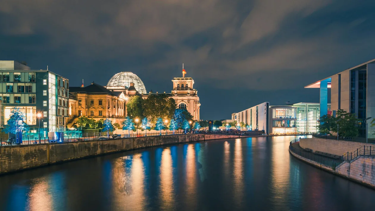 Reichstag building and Spree River illuminated at night in Berlin