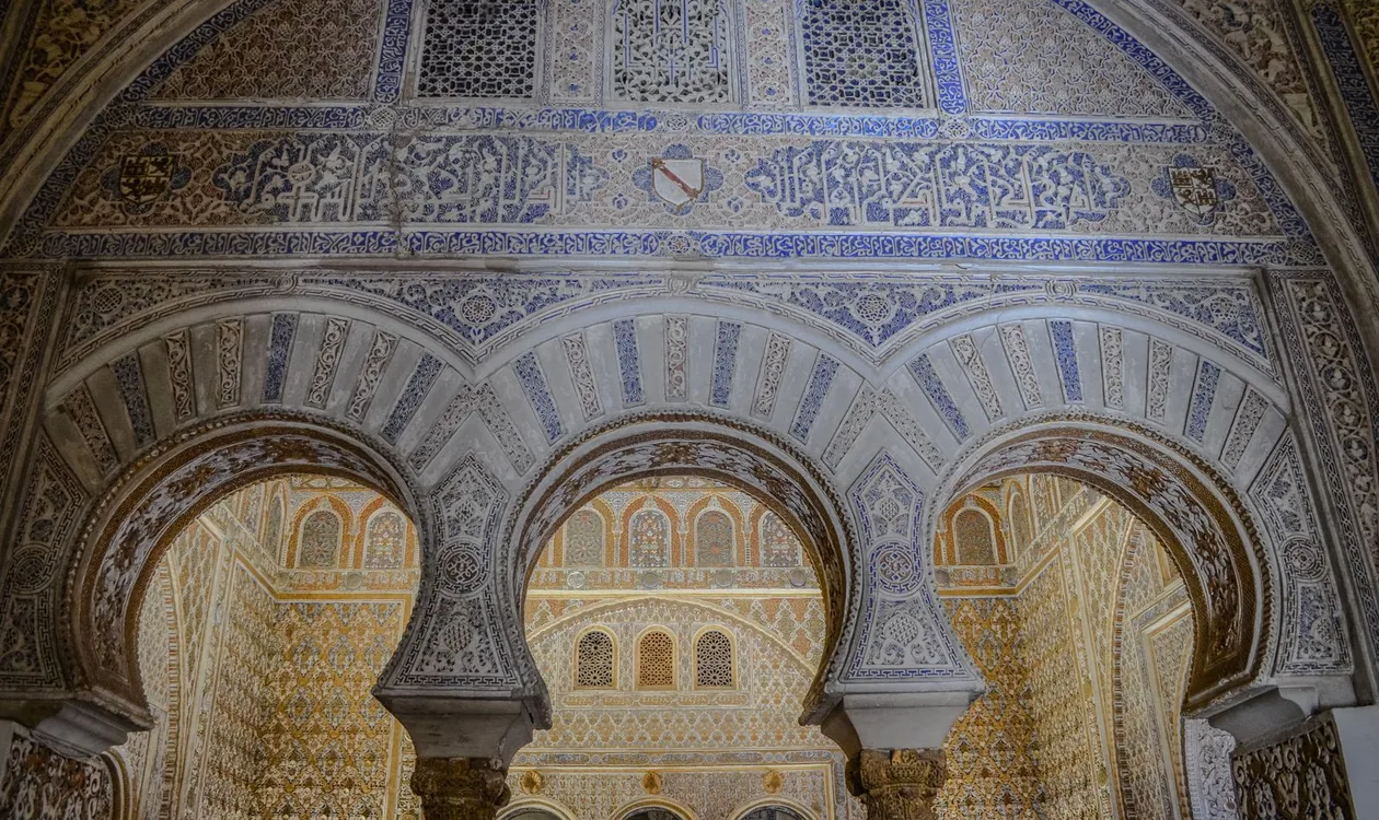 Mudéjar horseshoe arches and carved tilework inside the Royal Alcázar of Seville